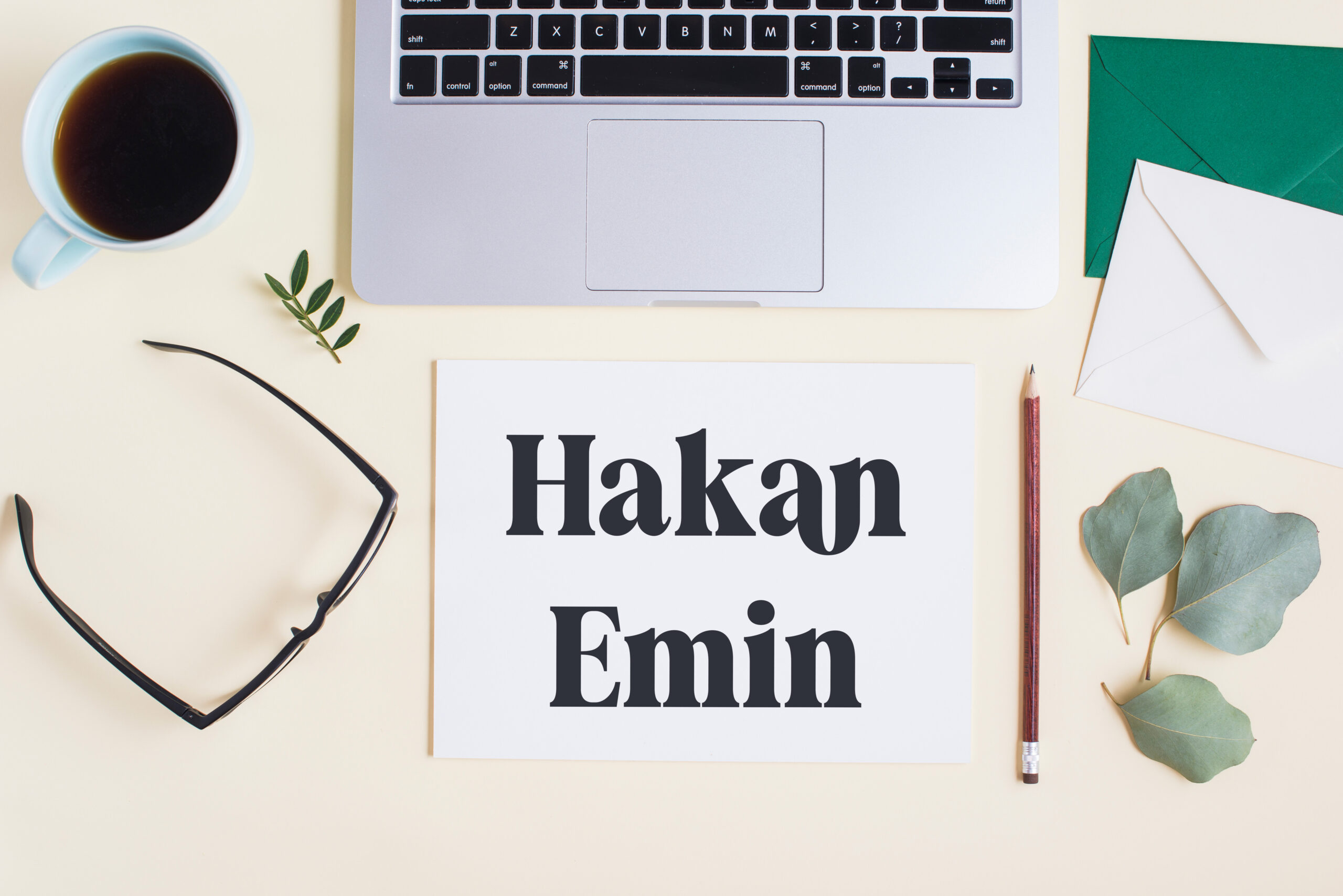 overhead-view-laptop-with-stationeries-tea-cup-colored-backdrop